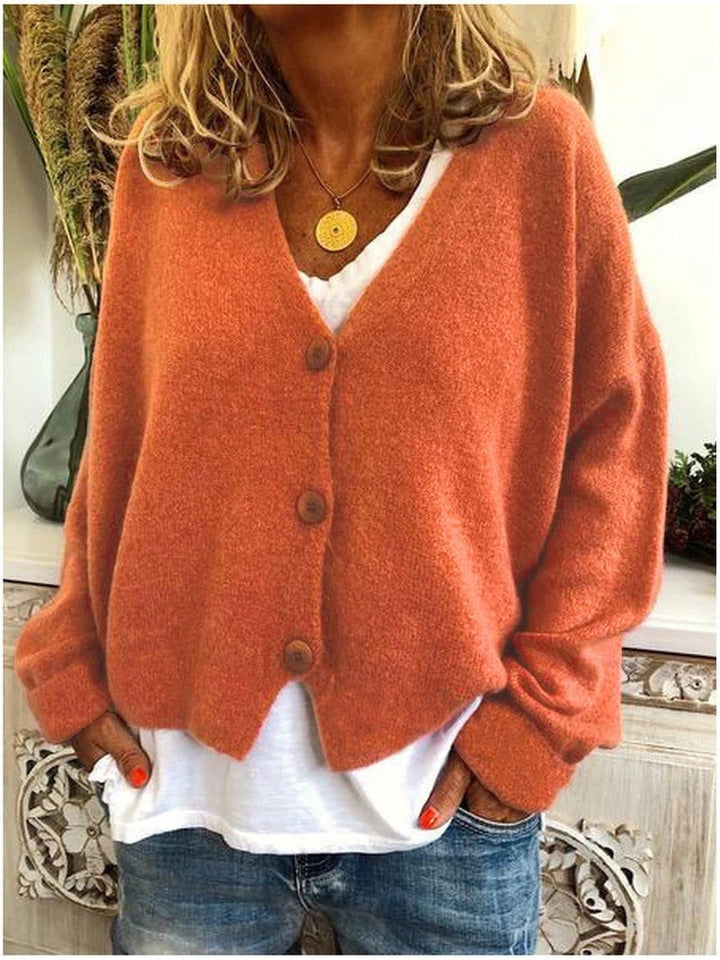 Orangefarbene Strickjacke mit V-Ausschnitt und Knopfleiste im Oversize-Schnitt
