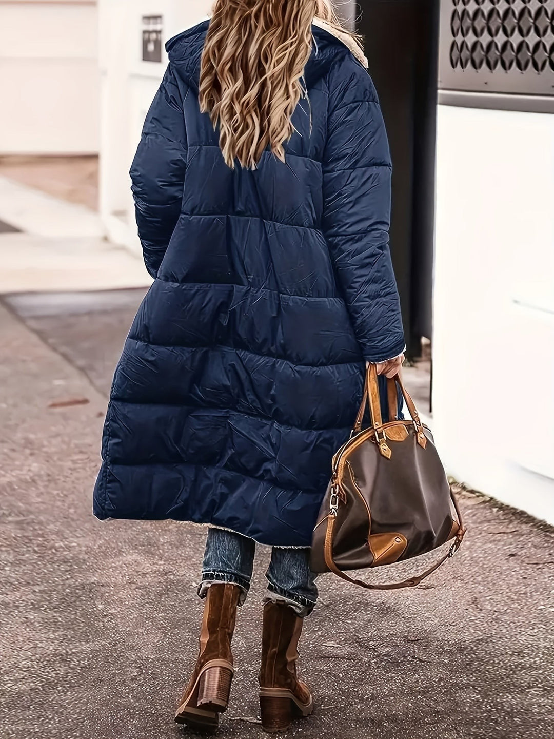 Dunkelblaue lange Steppjacke von hinten mit Kapuze und Teddyfutter