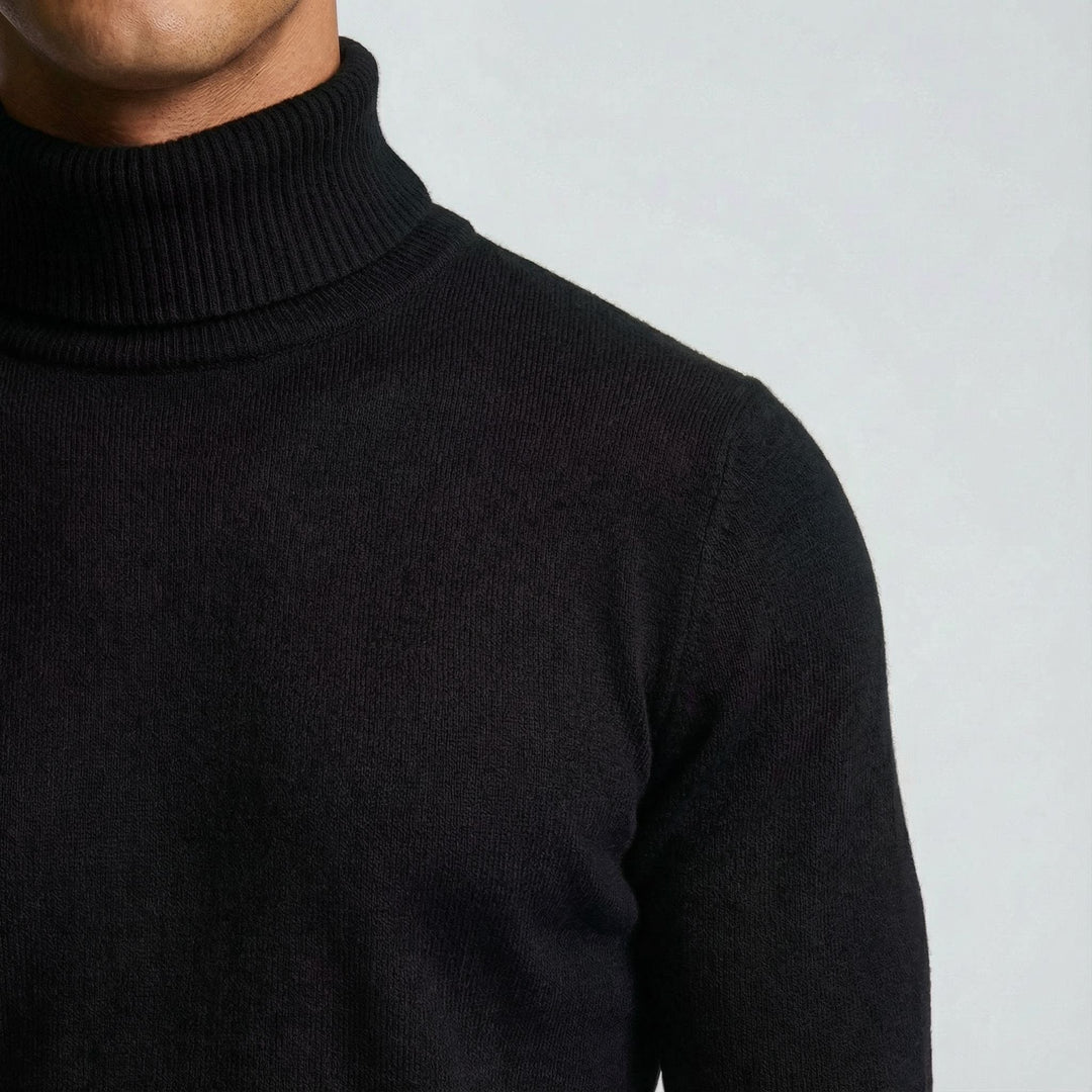 Schulterdetail eines schwarzen Rollkragenpullovers aus feinem Strickmaterial