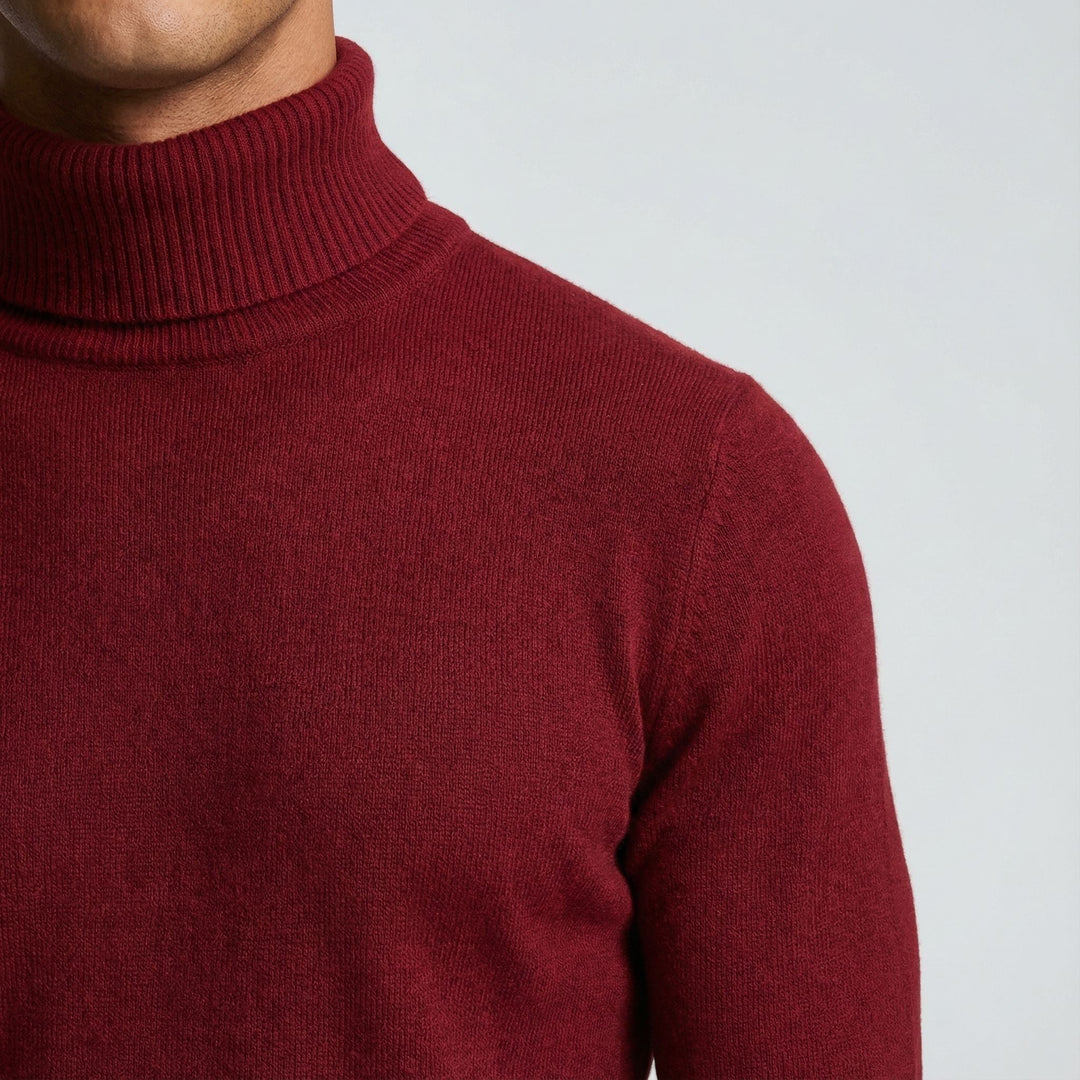 Nahaufnahme Rollkragen und Schulterpartie eines bordeauxroten Feinstrickpullovers