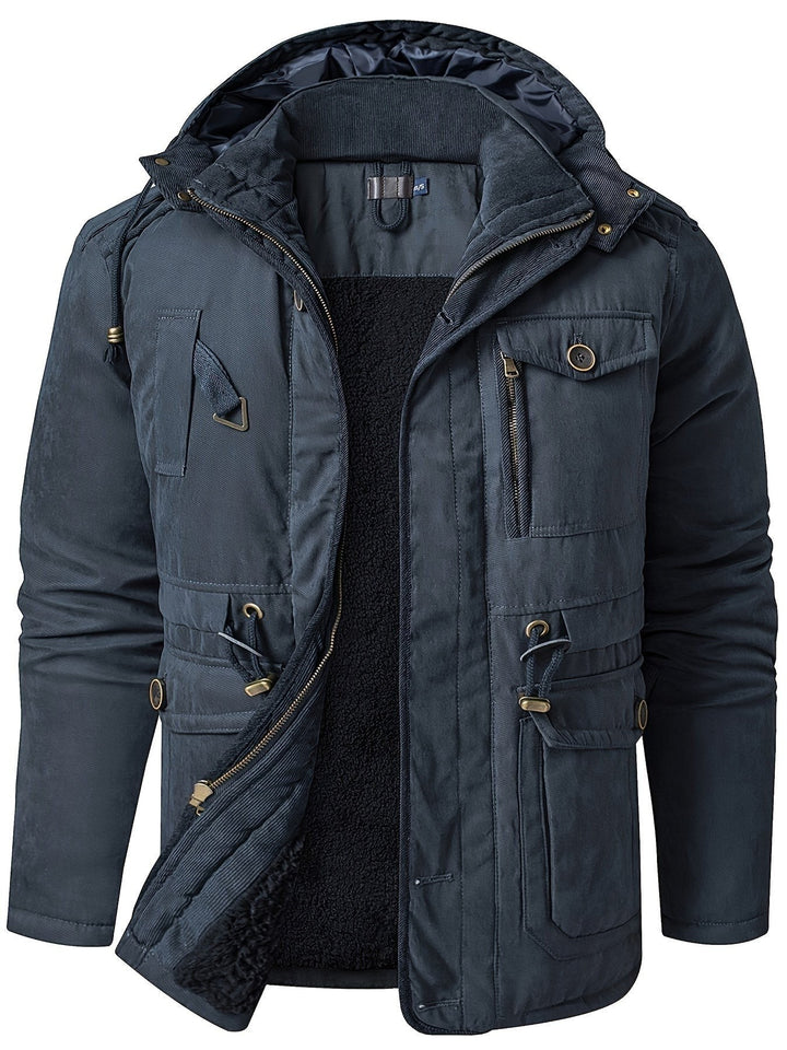 Dunkelblaue Winterjacke mit Kapuze und aufgesetzten Taschen