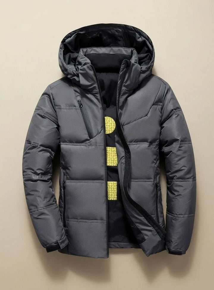Dunkelgraue Steppjacke mit Kapuze und funktionalen Reißverschlusstaschen